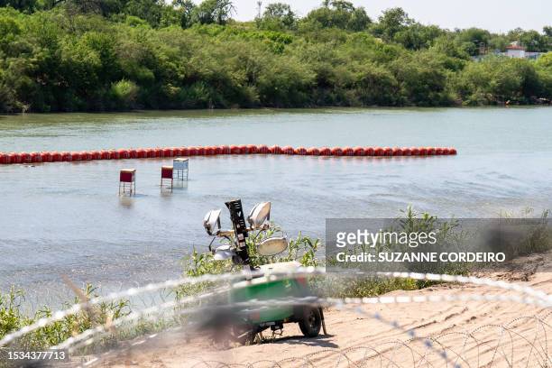 View of a string of buoys placed on the water along the Rio Grande border with Mexico in Eagle Pass, Texas, on July 15 to prevent illegal immigration...