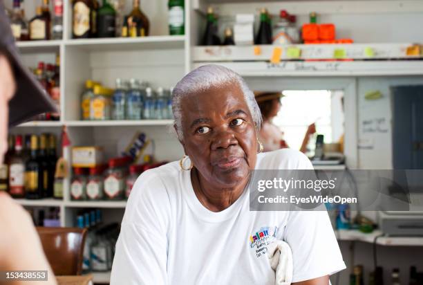 Portrait of an old bahamian lady who is selling beer and alcohol in a small restaurant and bar on June 15, 2012 in Cat Island, The Bahamas.