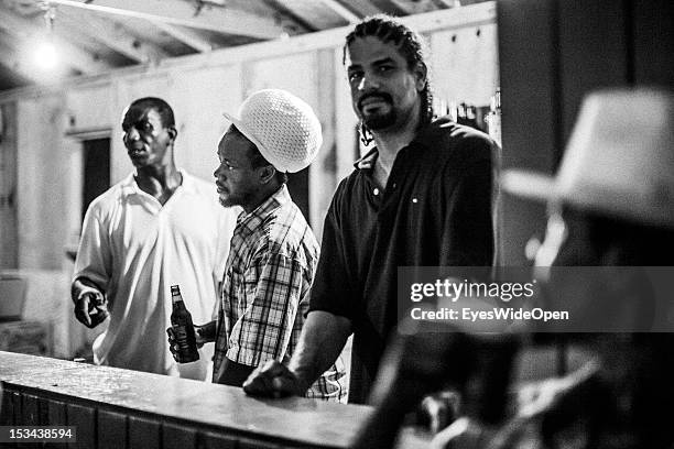 Local bahamian young men with rasta dreadlocks hair are selling drinks and beer at the annual Rake 'n' Scrape Festival on June 15, 2012 in Cat...