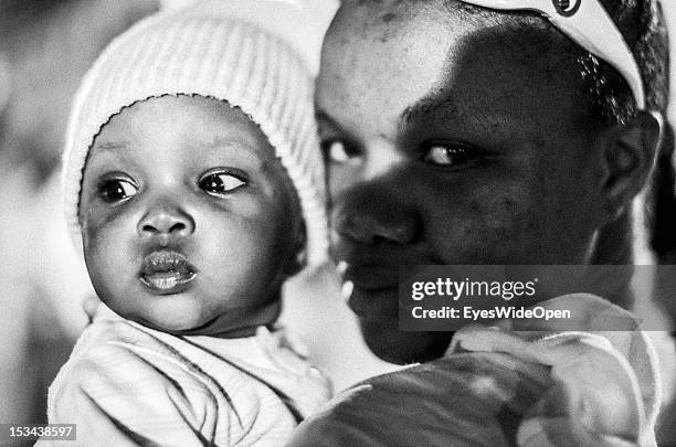 Black and white portrait of a local bahamian young mother with her baby child at the annual Rake 'n' Scrape Festival on June 15, 2012 in Cat Island,...