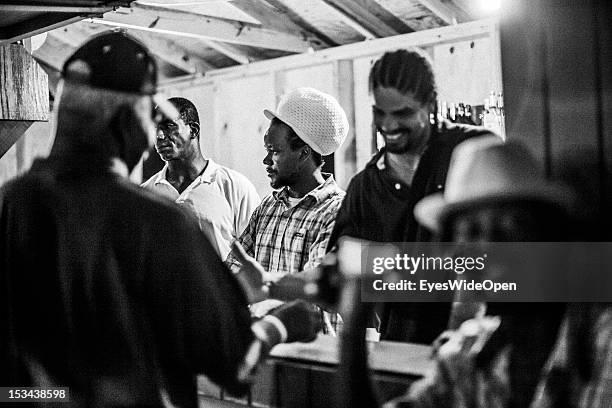 Local bahamian young men with rasta dreadlocks hair are selling drinks and beer at the annual Rake 'n' Scrape Festival on June 15, 2012 in Cat...