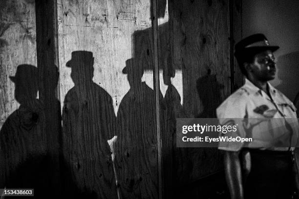 Black and white portrait of a local bahamian female police officer and shadows of her woman colleagues at the annual Rake 'n' Scrape Festival on June...