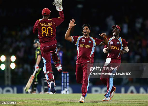 Ravi Rampaul of the West Indies celebrates the wicket of Cameron White of Australia with Denesh Ramdin and Darren Sammy during the ICC World Twenty20...