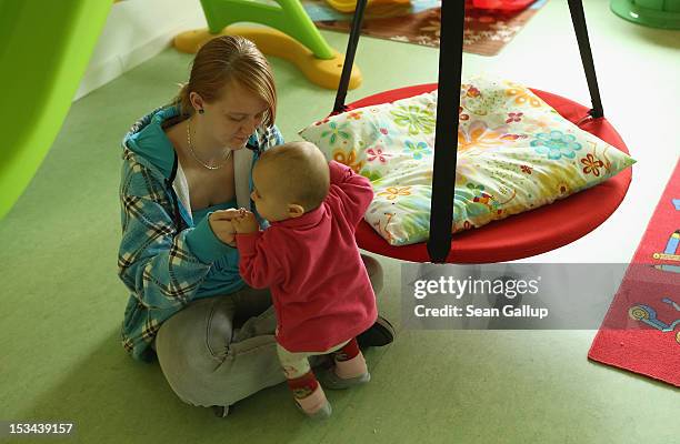 Single mother Nancy Kett plays with her 11-month-old daughter Lucy in the playroom of the "Jule" facility for single parents in Marzahn-Hellersdorf...