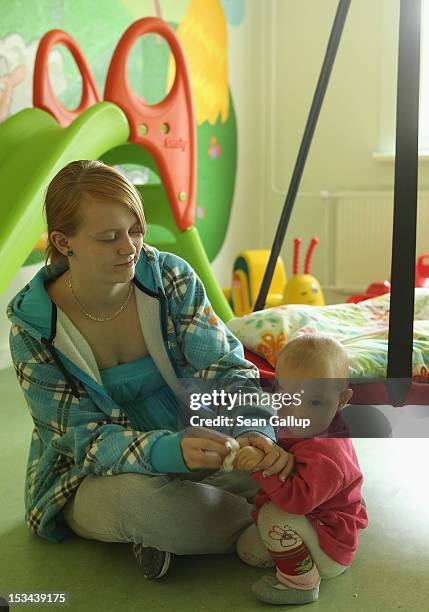 Single mother Nancy Kett plays with her 11-month-old daughter Lucy in the playroom of the "Jule" facility for single parents in Marzahn-Hellersdorf...