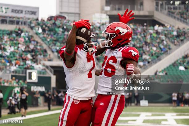 Tommylee Lewis and Dedrick Mills of the Calgary Stampeders celebrate after a touchdown in the game between the Calgary Stampeders and Saskatchewan...