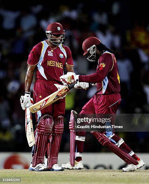 West Indien player Chris Gayle reacts after Kieron Pollard played a reverse shot during the ICC T20 World Cup cricket semi final match between...