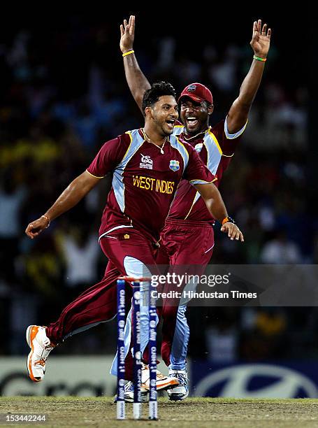 West Indien player Ravi Rampaul celebrates after the dismissal of Australian batsman David Hussey during the ICC T20 World Cup cricket semi final...