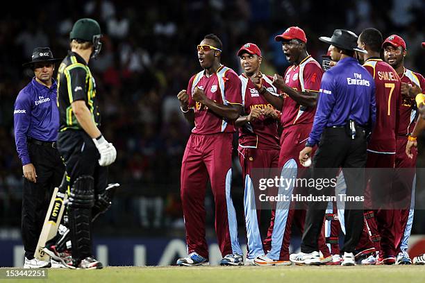 West Indian player Captain Darren Sammy and team react to Australian player Shane Watson after dismissal of David Warner during the ICC T20 World Cup...