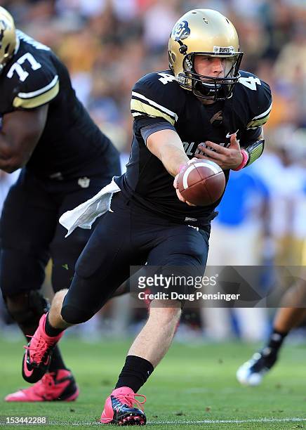 Quarterback Jordan Webb of the Colorado Buffaloes hands the ball off against the UCLA Bruins at Folsom Field on September 29, 2012 in Boulder,...