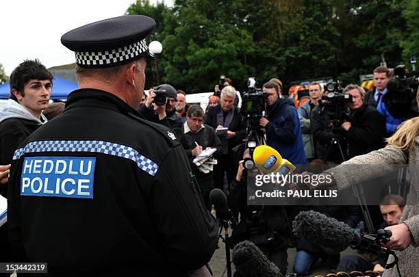 Police Superintendant Ian John speaks during a press conference in Machynlleth, mid-Wales, on October 5, 2012 as the search for missing five-year-old...