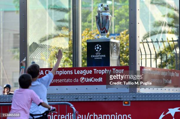 Fan shows his enthusiasm as a truck passes with the UEFA Champions League Trophy during the UEFA Champions League Trophy Tour 2012/13 at Piazzale del...