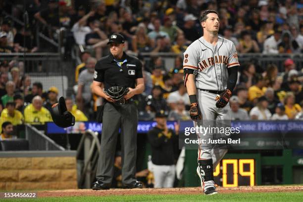 Mike Yastrzemski of the San Francisco Giants tosses away his batting helmet after striking out in the fourth inning against the Pittsburgh Pirates at...