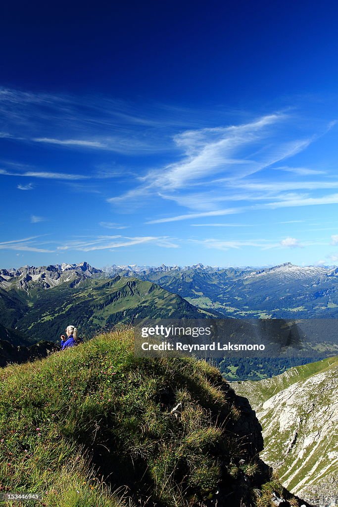 Woman on top of mountain