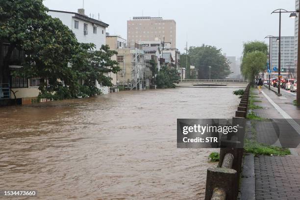 This photo taken on July 15, 2023 shows the levels of the Asahikawa river swollen due to heavy rains across the prefecture in northern Japan, in the...