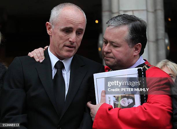 Michael McKeon , uncle of Jill Meagher, is comforted outside St.Peters Catholic church in Drogheda, Ireland on October 5, 2012. A memorial mass was...