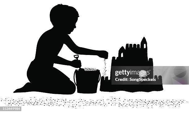 boy building a sandcastle on the beach - children playing silhouette stock illustrations