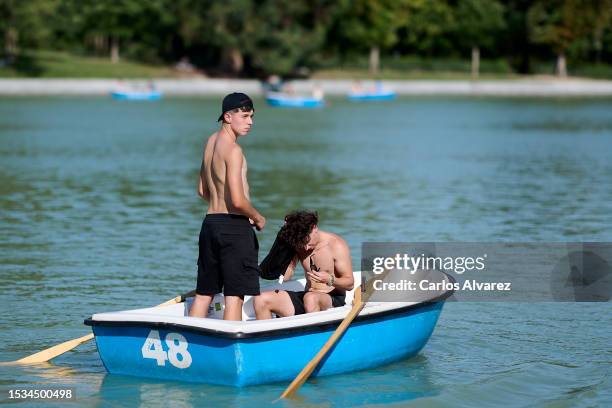 Two men enjoy a boat in the pond at the Retiro Park on July 11, 2023 in Madrid, Spain. With an ongoing drought and heatwave credited to climate...