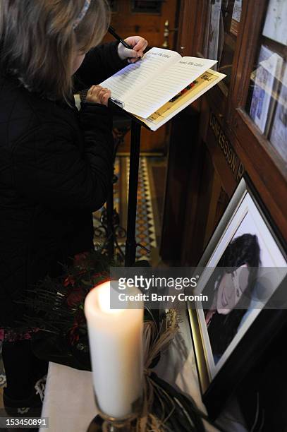 Young girl signs a book of condolence prior to a Memorial Service for murdered journalist Jill Meagher at St. Peter's Church on October 5, 2012 in...