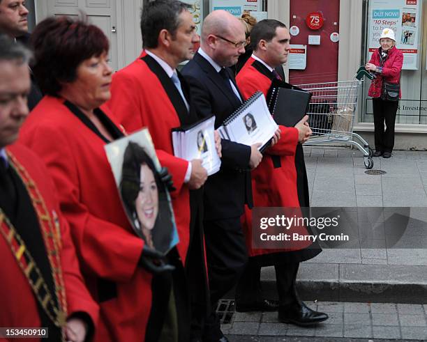 Shopper watches a procession led by Mayor of Drogheda Paul Bell on their way to the Memorial Service for murdered journalist Jill Meagher at St....