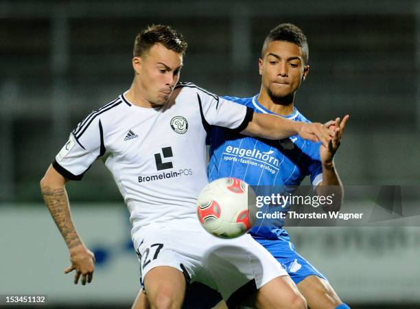 Kevin Feiersinger of Elversberg battles for the ball with Jeremy Toljan of Hoffenheim during the fourth league match between SV Elversberg and TSG...