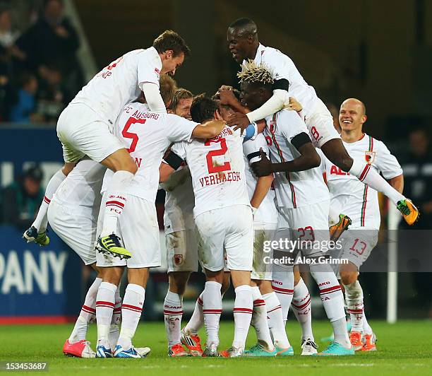 Daniel Baier of Augsburg celebrates his team's third goal with team mates during the Bundesliga match between FC Augsburg and SV Werder Bremen at SGL...