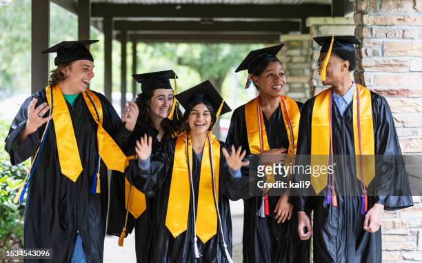 five multiracial high school graduates standing outdoors - black man high 5 stockfoto's en -beelden