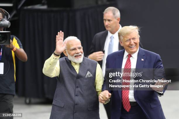 India's prime minister, Narendra Modi and President Donald Trump walk hand and hand around NRG Stadium after the Howdy Modi event Sunday, Sept. 22 in...