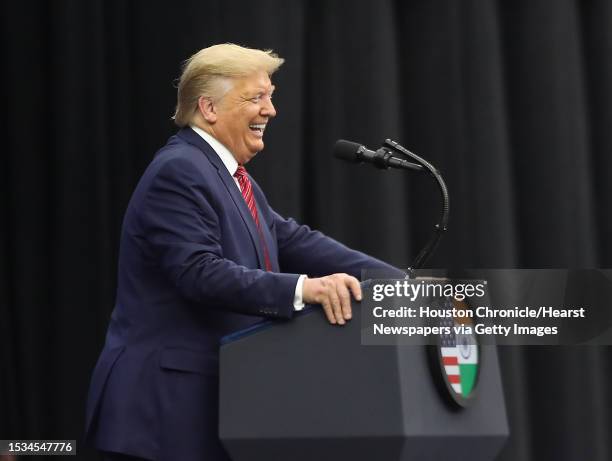 President Donald Trump laughs as he talks during a Howdy Modi event for India's prime minister, Narendra Modi at NRG Stadium Sunday, Sept. 22 in...