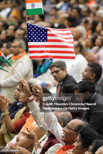 Supporter of India's prime minister, Narendra Modi and President Donald Trump waves flags during the Howdy Modi event at NRG Stadium day, Sept. 22 in...