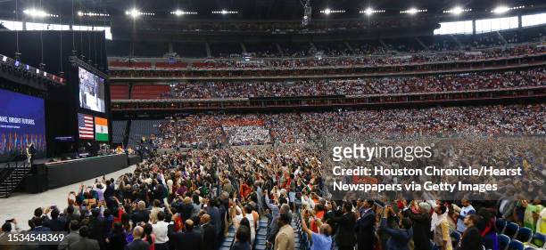 Supporters of India's prime minister, Narendra Modi and President Donald Trump cheer during the Howdy Modi event at NRG Stadium day, Sept. 22 in...