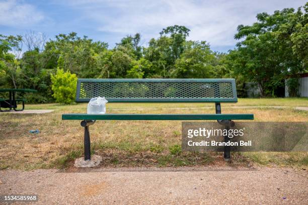 An Austin Area Urban League water pouch is seen on a park bench in the Hungry Hill neighborhood on July 11, 2023 in Austin, Texas. Record-breaking...