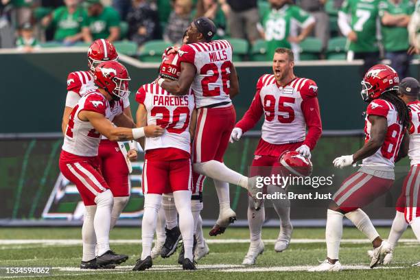 René Paredes of the Calgary Stampeders is congratulated by teammates after kicking the game winning field goal in the game between the Calgary...