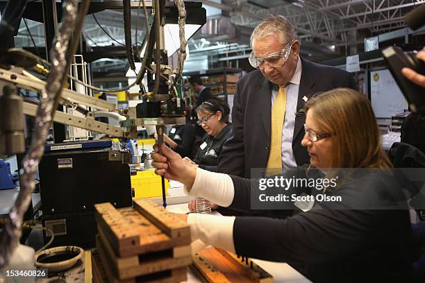 Former Wisconsin Governor and current Republican candidate for the state's U. S. Senate seat Tommy Thompson visits with Fran Hudspeth during a...