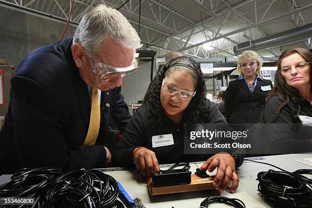 Former Wisconsin Governor and current Republican candidate for the state's U. S. Senate seat Tommy Thompson visits with Mara Warren during a campaign...