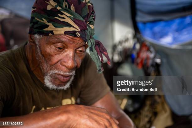 John Mason sits in his tent in the Hungry Hill neighborhood on July 11, 2023 in Austin, Texas. Mason is a homeless resident residing in the Hungry...