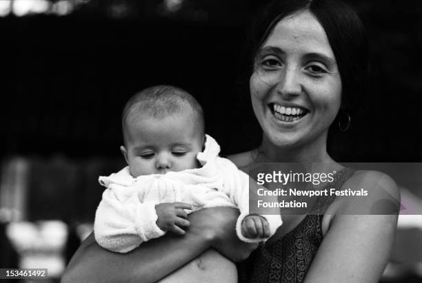 Folk and blues singer and member of Jim Kweskin Jug Band Maria Muldaur poses for a portrait with her newborn daughter backstage at the Newport Folk...