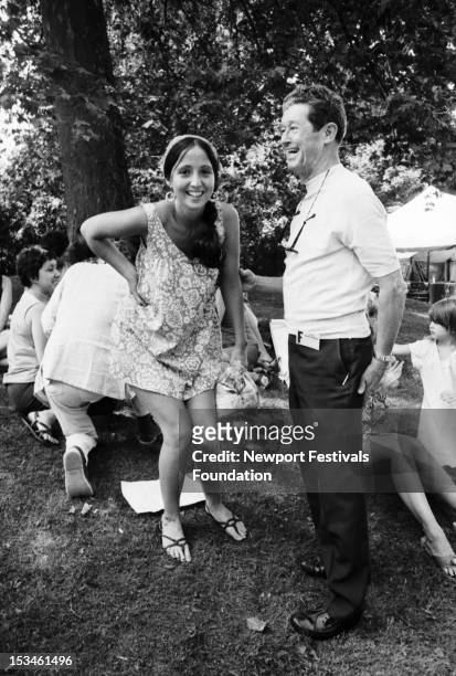 Singer Maria Muldaur and country singer and bandleader Roy Acuff pose for a portrait together backstage at the Newport Folk Festival in July, 1968 in...
