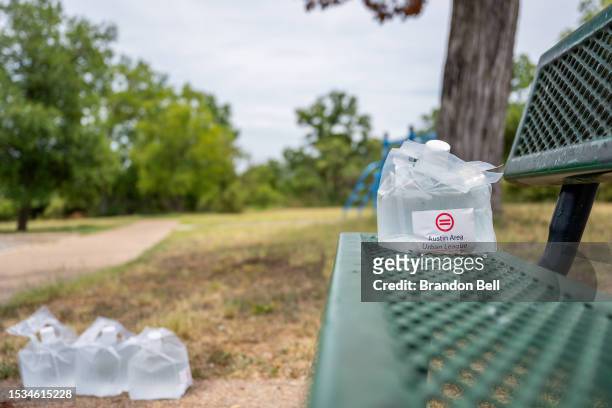 Austin Area Urban League water pouches are seen on a park bench in the Hungry Hill neighborhood on July 11, 2023 in Austin, Texas. Record-breaking...
