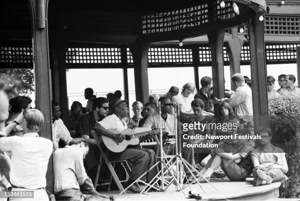 Country blues guitarist and singer Mississippi John Hurt performs at the Newport Folk Festival in July, 1963 in Newport, Rhode Island. Folk musician...