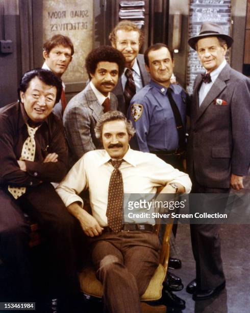 American actor Hal Linden , as Captain Barney Miller, with the cast of the American TV police comedy series 'Barney Miller', circa 1978. Other cast...