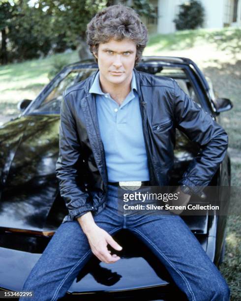 American actor David Hasselhoff, star of the TV show 'Knight Rider' sitting on KITT, the artificially intelligent supercar featured in the series,...