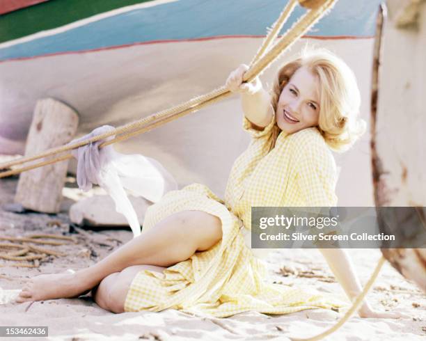 American actress Angie Dickinson wearing a yellow gingham dress, circa 1955.