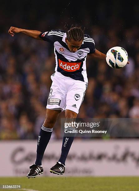 Jonathan Bru of the Victory heads the ball during the round one A-League match between the Melbourne Victory and the Melbourne Heart at Etihad...