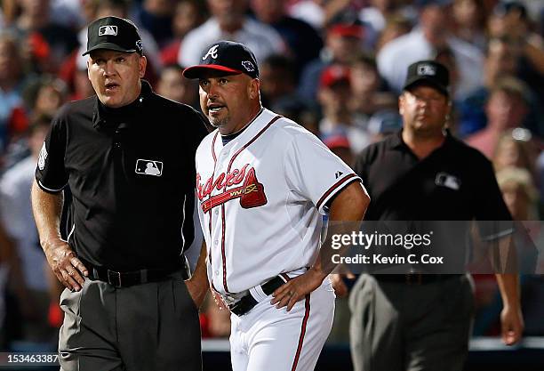 Manager Fredi Gonzalez of the Atlanta Braves argues an infield fly ruling in the eighth inning with third base umpire Jeff Nelson and left field...