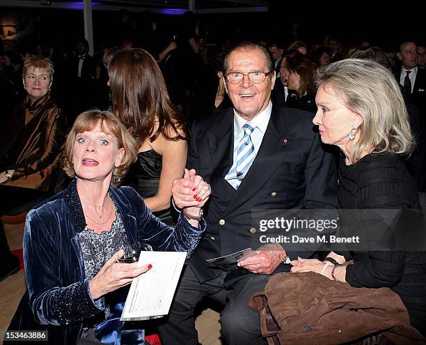 Samantha Bond, Sir Roger Moore and wife Christina Tholstrup attend '50 Years Of James Bond: The Auction', celebrating the 50th anniversary of the...