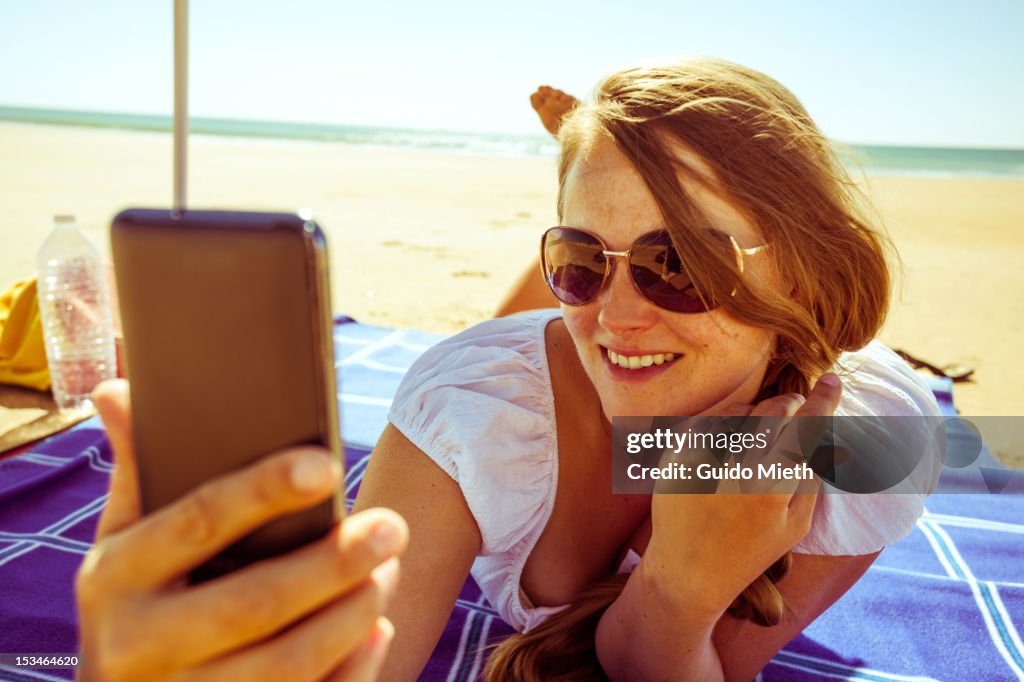 Smiling woman photographing herself