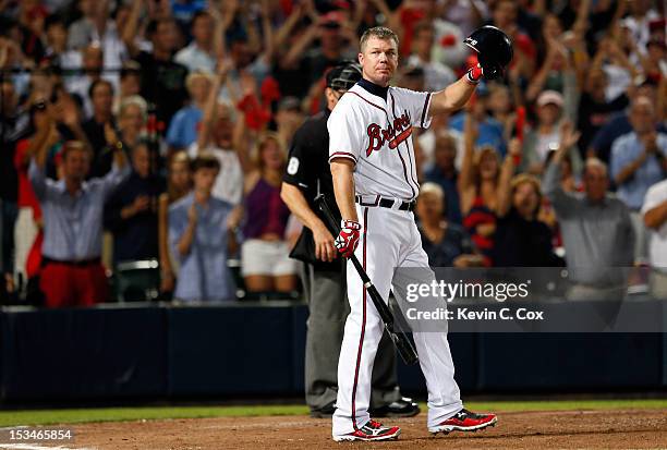 Chipper Jones of the Atlanta Braves tips his helmet to the crowd before his final at bat before the Braves lose to the St. Louis Cardinals 6-3 during...