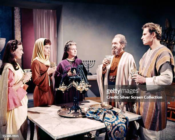 Judah Ben-Hur, played by Charlton Heston , drinking a toast with his family in a scene from 'Ben-Hur', directed by William Wyler, 1959. Left to...