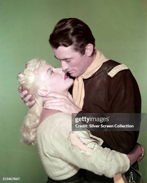 American actors Gregory Peck and Barbara Payton kiss in a publicity still for 'Only the Valiant', directed by Gordon Douglas, 1951.